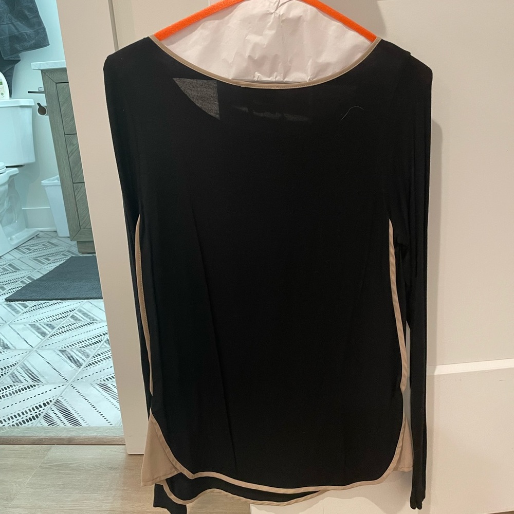 Black long sleeve, thin material with tan detail at the sides.